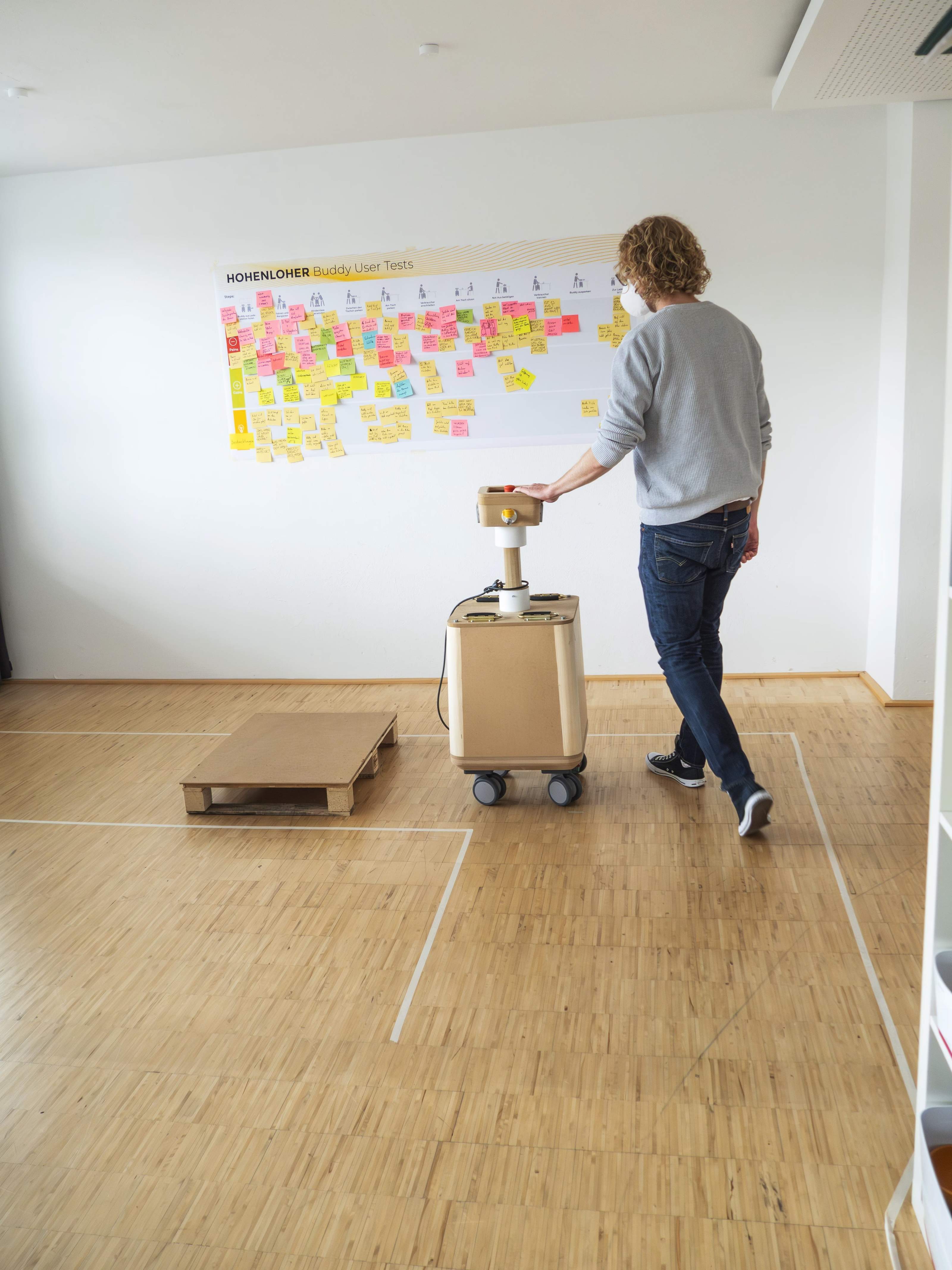 Person pushing the medienBuddy prototype across a marked test area