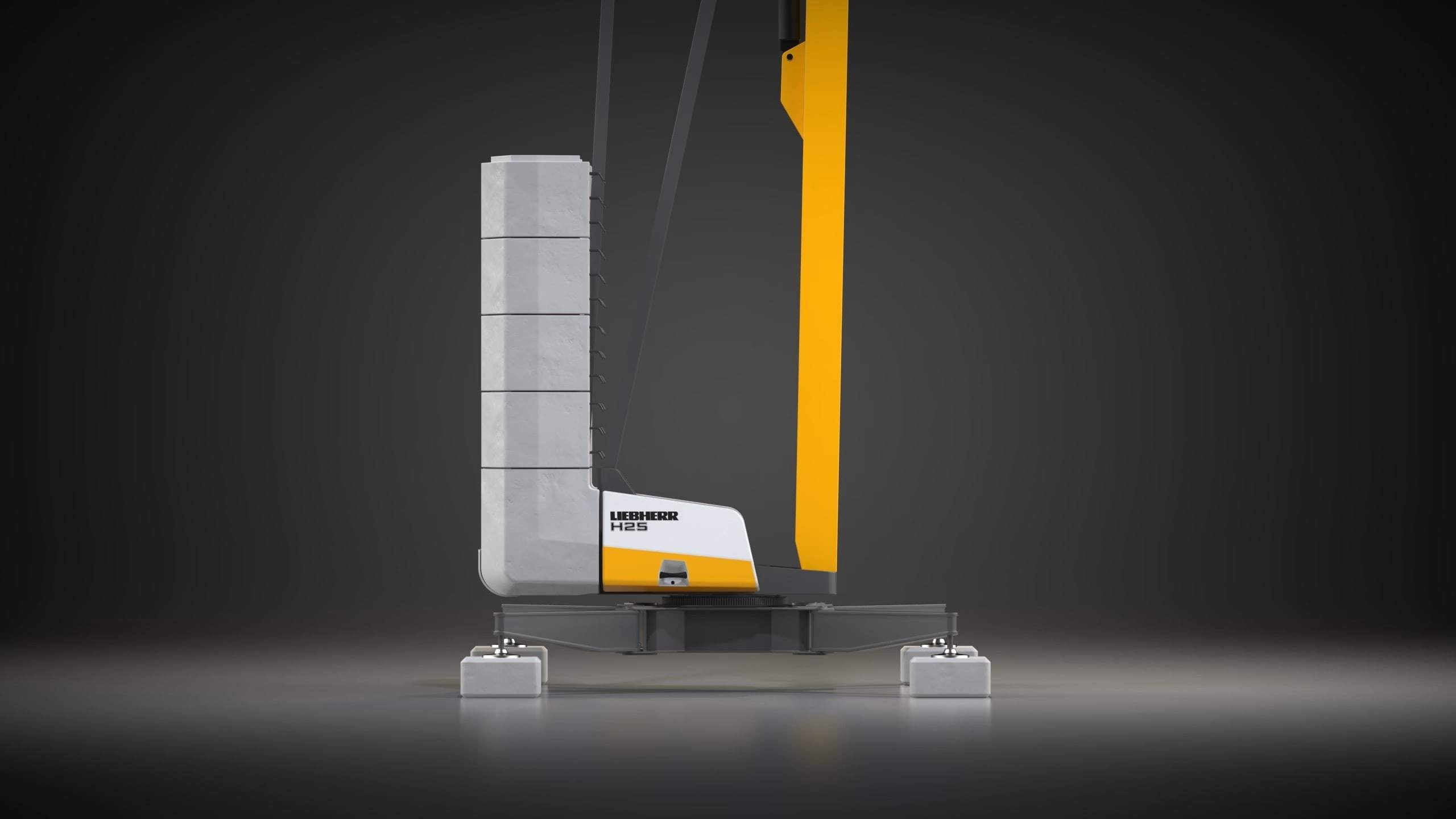 Side view of the crane base with ballast block and tower against a dark background